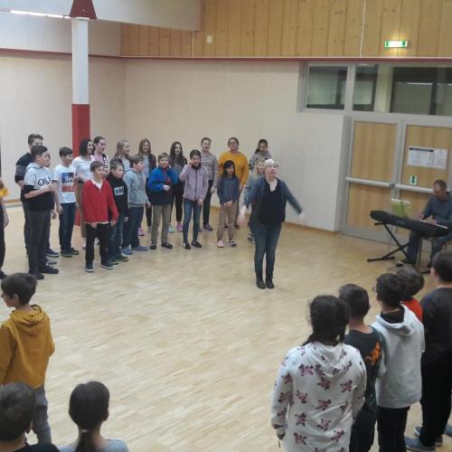 Schulchor singt vor Volksschülern ein Lied